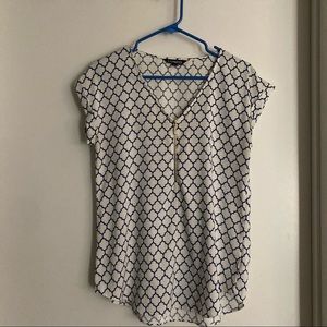 White and blue patterned blouse. Small. Express. Circle hem. Slight v neck.